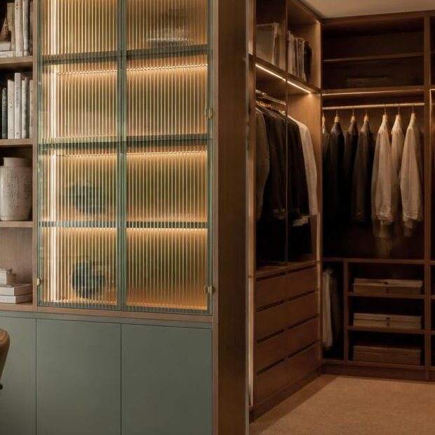 Walk-in wardrobe with lit fluted glass display cabinet