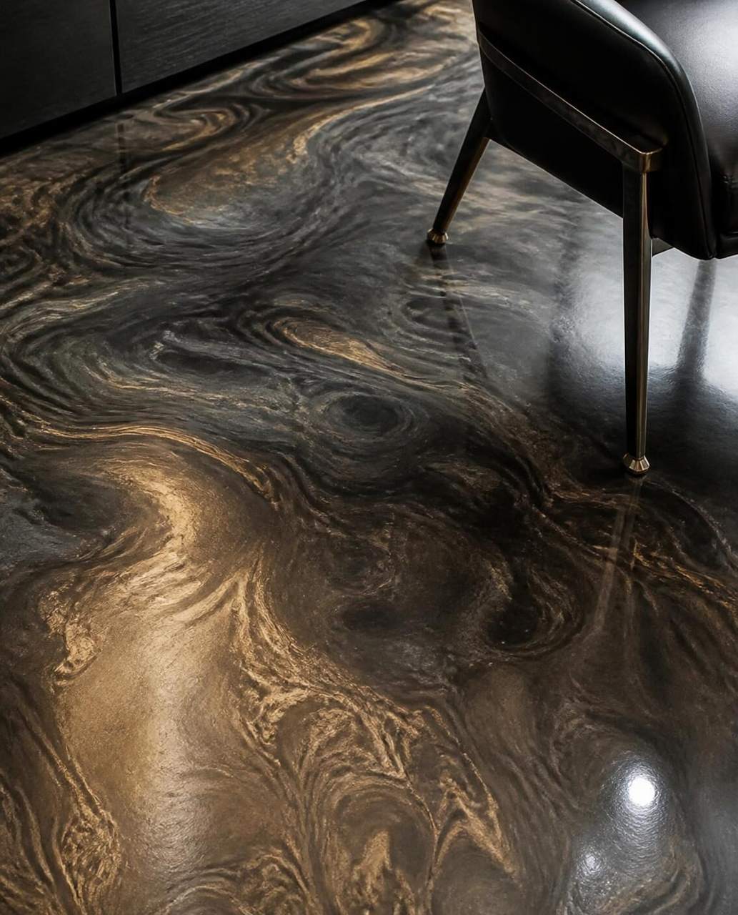 Close-up of charcoal and gold metallic epoxy swirls